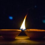 Rows of lit clay diyas glowing during Diwali, the festival of lights
